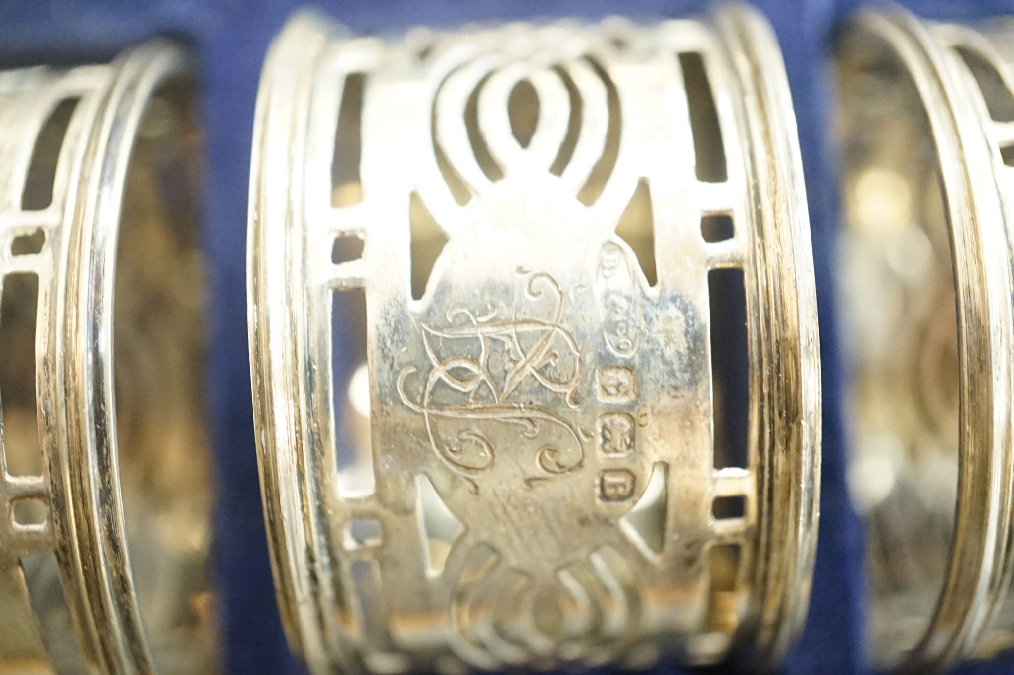 A cased set of six George V pierced silver napkin rings, Birmingham, 1926.